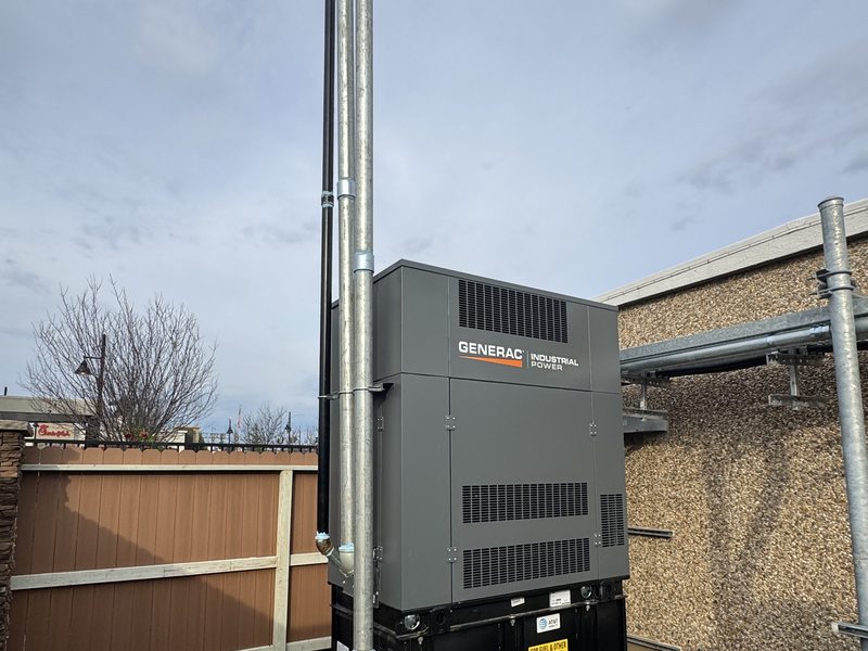 Generac generator with exhaust stack and conduit at an urban shelter site